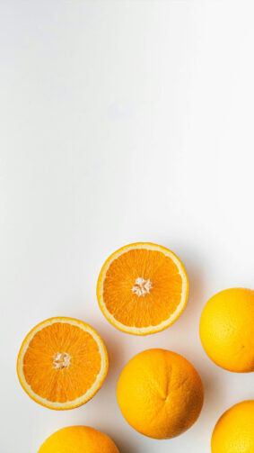 Clean Whole and Half Oranges White Background 4K Ultra HD Mobile Phone Wallpaper